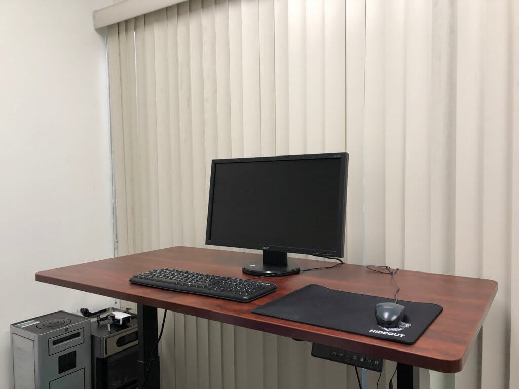 Aimezo's dual-motor electric standing desk at work in the Newegg offices for better workplace health.