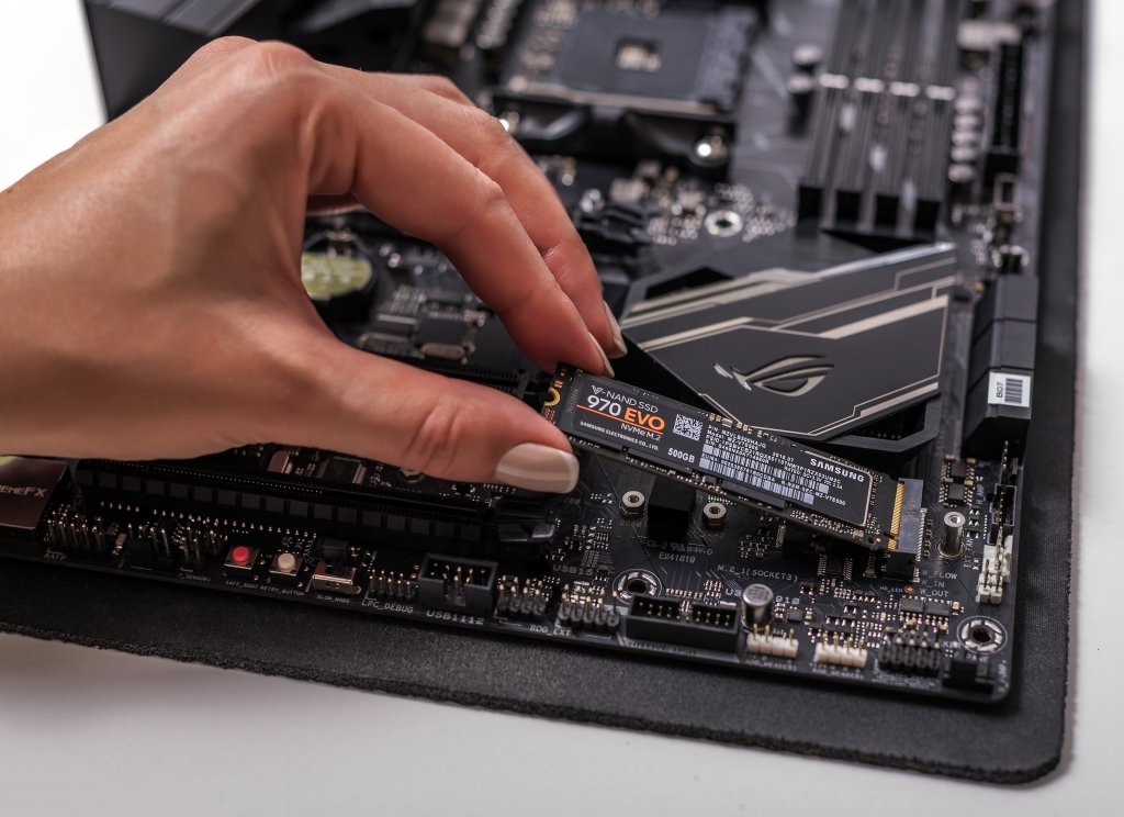 A Female Hand Installing an M.2 SSD hard drive into Its Motherboard Slot, Best Storage for Desktop PCs